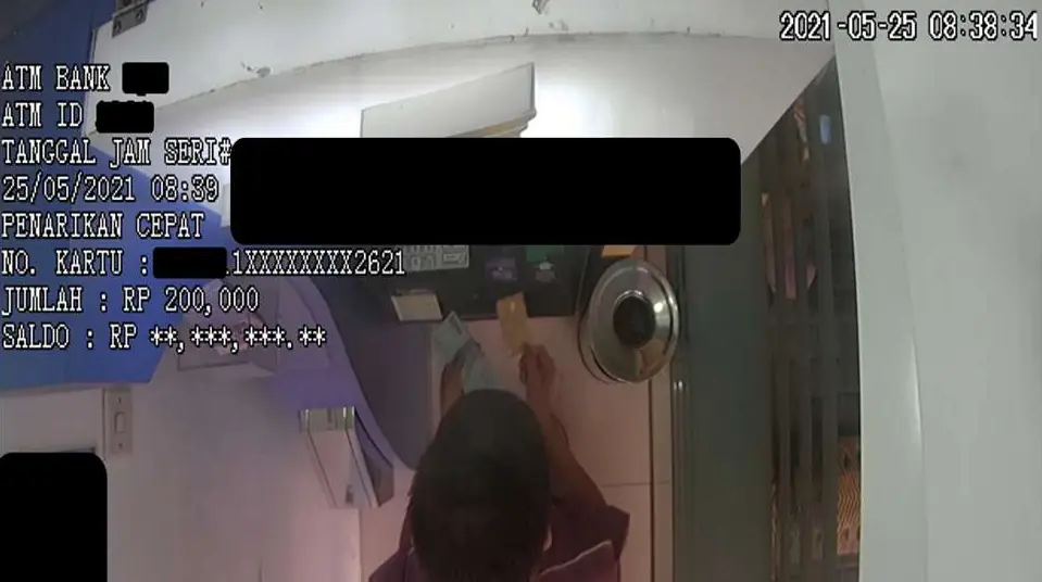 ATM CCTV footage seen from above, with withdrawal data printed on the video as a text overlay; sensitive fields masked