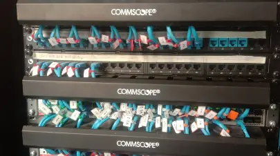 Server rack with patch panels and labelled blue network cables
